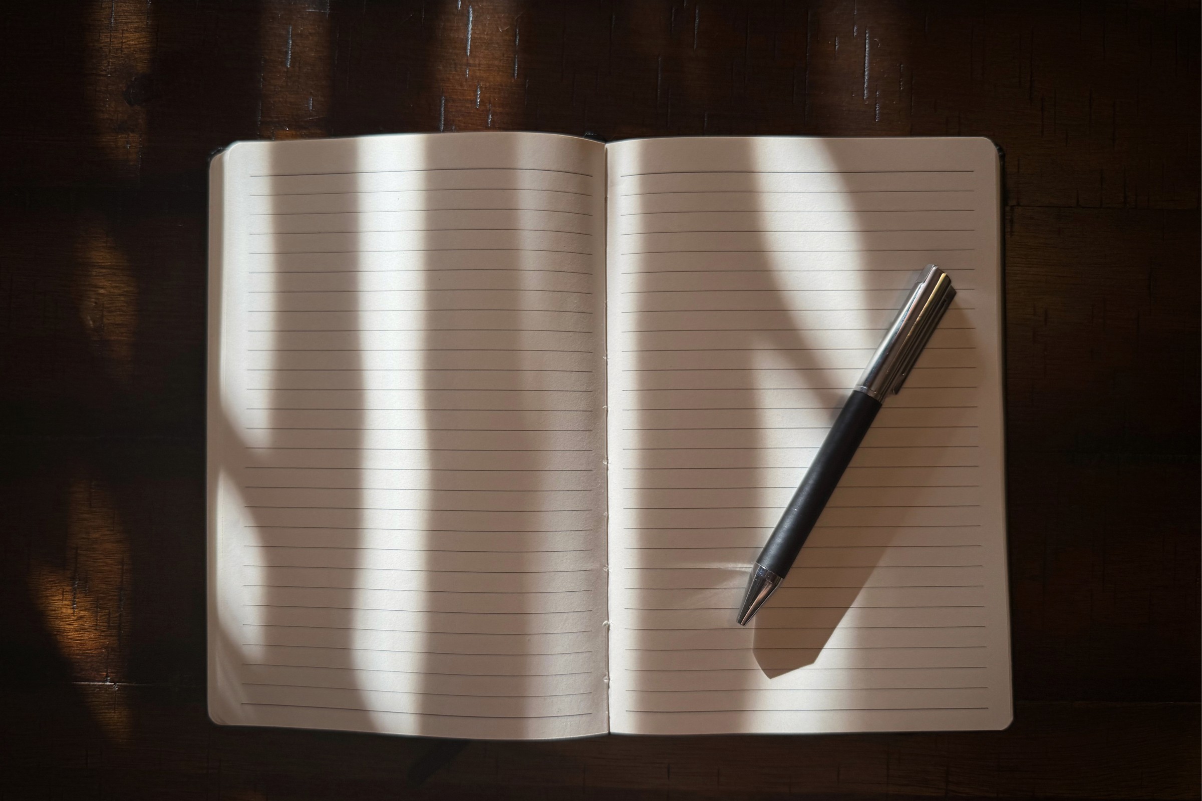 open journal with strong shadows and blank pages