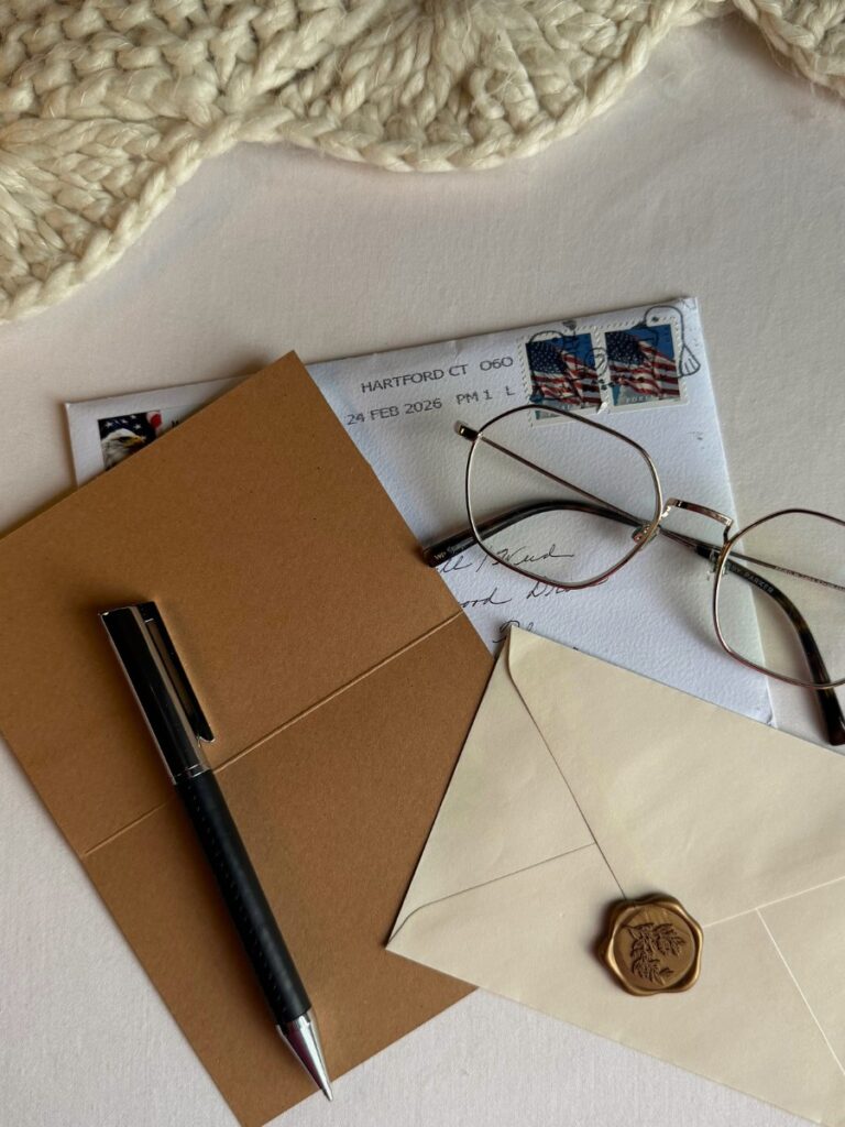 journal and envelope on table with soft natural lighting